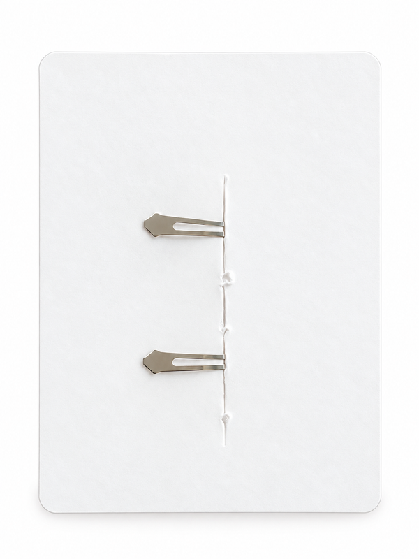 Reverse of cream daisy crochet hair clips, showing clip fastenings