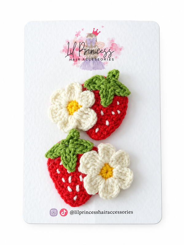 Red version of Strawberry and Daisy Crochet Hair Clips shown together
