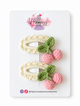 Pink version of Cherry Crochet Hair Clips in Pink or Red shown together